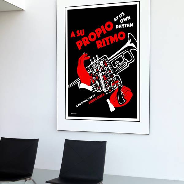 Modern interior with framed Cuban silkscreen poster for the documentary ‘A Su Propio Ritmo’ by Jorge Ayala. Designed in bold black, red, and white, the poster features a stylized trumpet with red-gloved hands and tiny musical instruments.